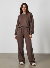 Vector Sportswear Lounge Strides wide-leg pants with elastic waist and piping detail for modern style.
